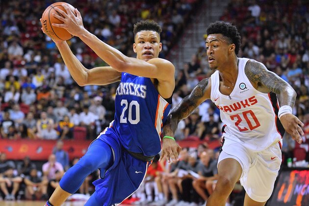 LAS VEGAS, NV - JULY 07:  Kevin Knox #20 of the New York Knicks drives against John Collins #20 of the Atlanta Hawks during the 2018 NBA Summer League at the Thomas & Mack Center on July 7, 2018 in Las Vegas, Nevada. NOTE TO USER: User expressly acknowledges and agrees that, by downloading and or using this photograph, User is consenting to the terms and conditions of the Getty Images License Agreement.  (Photo by Sam Wasson/Getty Images)
