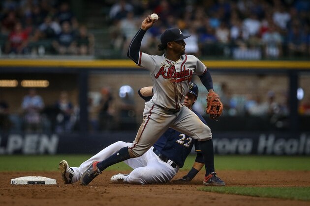 MILWAUKEE, WI - JULY 05:  Ozzie Albies #1 of the Atlanta Braves attempts to turn a double play past Christian Yelich #22 of the Milwaukee Brewers in the third inning at Miller Park on July 5, 2018 in Milwaukee, Wisconsin. (Photo by Dylan Buell/Getty Images)