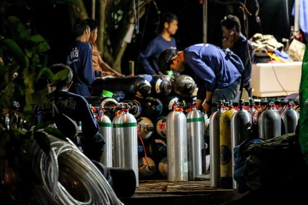 CHIANG RAI, THAILAND - JULY 6: Diving cylinders are prepared at a makeshift camp at the entrance of Tham Luang Nang Non caves for the divers to continue the rescue operation for the 12 trapped children and their coach on July 06, 2018 in Chiang Rai, Thailand. The 12 boys and their soccer coach have been found alive in the cave where they've been missing for over a week after monsoon rains blocked the main entrance in northern Thailand. Videos released by the Thai Navy SEAL shows the boys, aged 11 to 16, and their 15-year-old coach are in good health in Tham Luang Nang Non cave and the challenge now will be to extract the party safely. (Photo by Linh Pham/Getty Images)