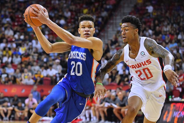 LAS VEGAS, NV - JULY 07:  Kevin Knox #20 of the New York Knicks drives against John Collins #20 of the Atlanta Hawks during the 2018 NBA Summer League at the Thomas & Mack Center on July 7, 2018 in Las Vegas, Nevada. NOTE TO USER: User expressly acknowledges and agrees that, by downloading and or using this photograph, User is consenting to the terms and conditions of the Getty Images License Agreement.  (Photo by Sam Wasson/Getty Images)