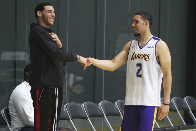 LiAngelo Ball, right, greets his brother, Los Angeles Lakers guard Lonzo Ball, after a pre-draft workout workout at the Lakers' NBA basketball facility in El Segundo, Calif., Tuesday, May 29, 2018. (AP Photo/Reed Saxon)
