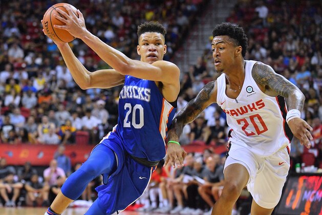 LAS VEGAS, NV - JULY 07:  Kevin Knox #20 of the New York Knicks drives against John Collins #20 of the Atlanta Hawks during the 2018 NBA Summer League at the Thomas & Mack Center on July 7, 2018 in Las Vegas, Nevada. NOTE TO USER: User expressly acknowledges and agrees that, by downloading and or using this photograph, User is consenting to the terms and conditions of the Getty Images License Agreement.  (Photo by Sam Wasson/Getty Images)