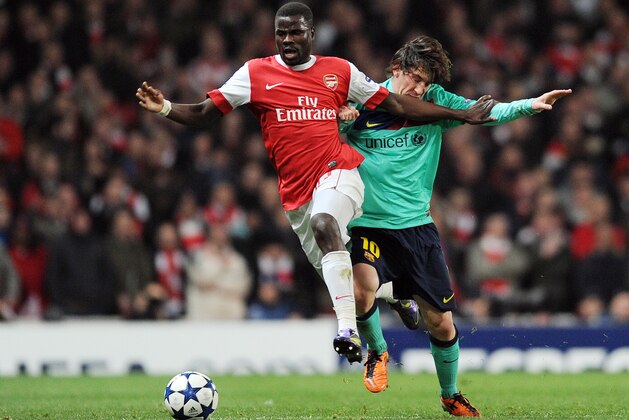 Arsenal's Ivorian defender Emmanuel Eboue (L) vies with Barcelona's Argentine striker Lionel Messi (R) during their UEFA Champions League round of 16 first leg football match at the Emirates Stadium in London, on February 16, 2011. AFP PHOTO / ADRIAN DENNIS (Photo credit should read ADRIAN DENNIS/AFP/Getty Images)