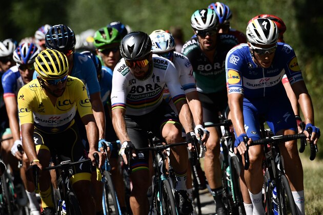 Colombia's Fernando Gaviria (L), wearing the overall leader's yellow jersey and Slovakia's Peter Sagan (C) talk as they ride ahead of the pack during the second stage of the 105th edition of the Tour de France cycling race between Mouilleron-Saint-Germain and La Roche-sur-Yon, western France, on July 8, 2018. (Photo by Jeff PACHOUD / AFP)        (Photo credit should read JEFF PACHOUD/AFP/Getty Images)