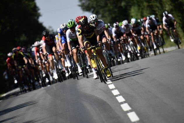 TOPSHOT - The pack rides during the second stage of the 105th edition of the Tour de France cycling race between Mouilleron-Saint-Germain and La Roche-sur-Yon, western France, on July 8, 2018. (Photo by Jeff PACHOUD / AFP)        (Photo credit should read JEFF PACHOUD/AFP/Getty Images)