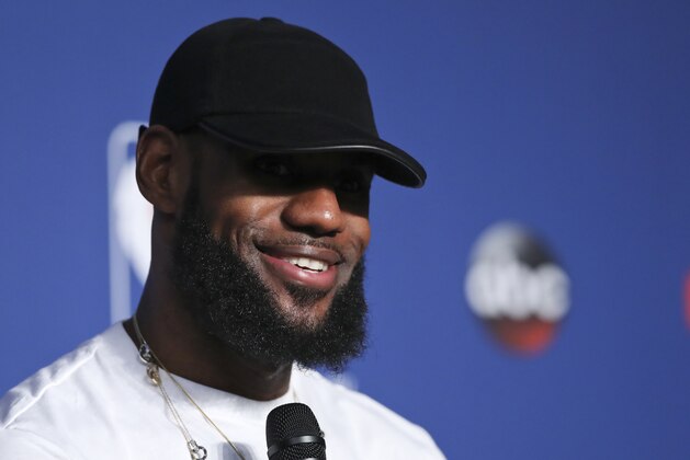 Cleveland Cavaliers forward LeBron James smiles during a news conference following Game 4 of basketball's NBA Finals against the Golden State Warriors, early Saturday, June 9, 2018, in Cleveland. The Warriors defeated the Cavaliers 108-85 to sweep the series and take the title. (AP Photo/Carlos Osorio)