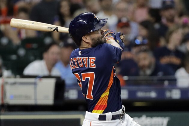 Houston Astros' Jose Altuve hits a home run against the Chicago White Sox during the fourth inning of a baseball game Sunday, July 8, 2018, in Houston. (AP Photo/David J. Phillip)
