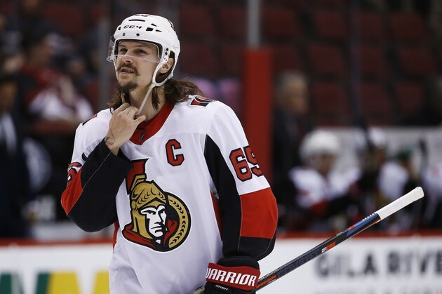 Ottawa Senators defenseman Erik Karlsson (65) adjusts his helmet during the second period of an NHL hockey game against the Arizona Coyotes Saturday, March 3, 2018, in Glendale, Ariz. The Coyotes defeated the Senators 2-1. (AP Photo/Ross D. Franklin)