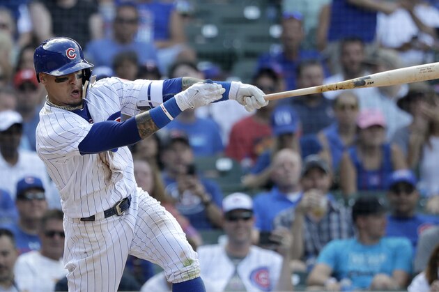 Chicago Cubs' Javier Baez hits a two-run double off Minnesota Twins relief pitcher Trevor Hildenberger during the seventh inning of a baseball game Saturday, June 30, 2018, in Chicago. Ian Happ and Kyle Schwarber scored. (AP Photo/Charles Rex Arbogast)