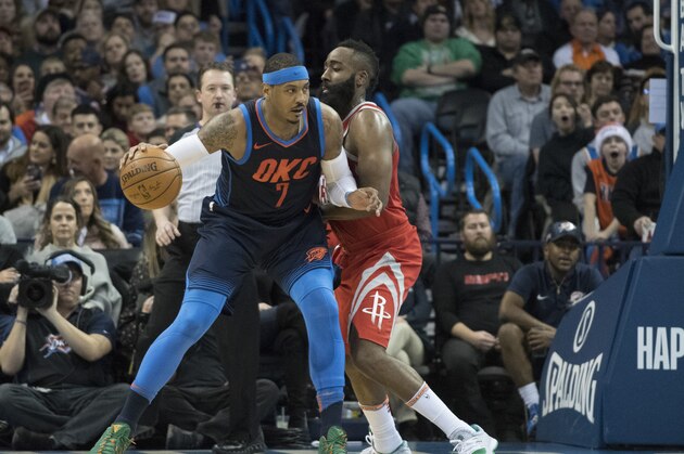 OKLAHOMA CITY, OK - DECEMBER 25: James Harden #13 of the Houston Rockets blocks Carmelo Anthony #7 of the Oklahoma City Thunder during the second half of a NBA  game at the Chesapeake Energy Arena on December 25, 2017 in Oklahoma City, Oklahoma. The Thunder defeated the Rockets 112-107. NOTE TO USER: User expressly acknowledges and agrees that, by downloading and or using this photograph, User is consenting to the terms and conditions of the Getty Images License Agreement. (Photo by J Pat Carter/Getty Images)