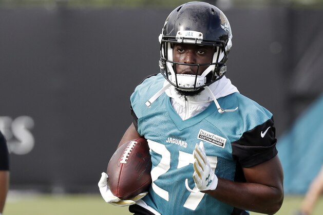 Jacksonville Jaguars running back Leonard Fournette (27) carries the ball after a reception during an NFL football practice Wednesday, June 13, 2018, in Jacksonville, Fla. (AP Photo/John Raoux)