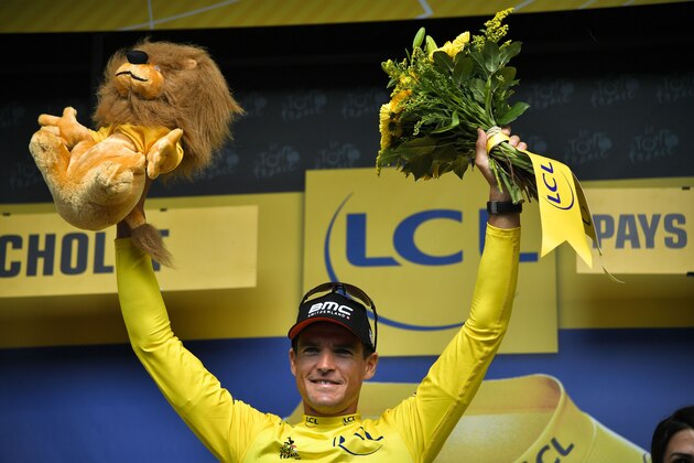 Belgium's Greg Van Avermaet, wearing the overall leader's yellow jersey, celebrates on the podium after the third stage of the 105th edition of the Tour de France cycling race, a 35.5 km team time-trial around Cholet, western France, on July 9, 2018. (Photo by Marco BERTORELLO / AFP)        (Photo credit should read MARCO BERTORELLO/AFP/Getty Images)