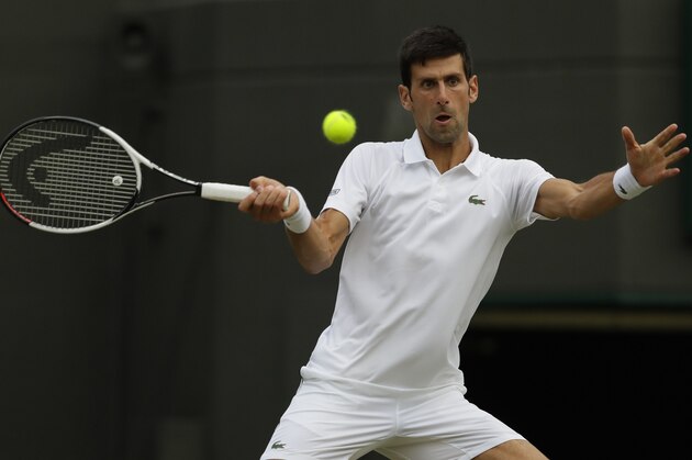 Novak Djokovic of Serbia returns a ball to Karen Khachanov of Russia during their men's singles match on the seventh day at the Wimbledon Tennis Championships in London, Monday July 9, 2018. (AP Photo/Kirsty Wigglesworth)