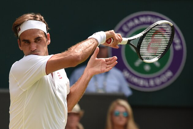 Switzerland's Roger Federer returns to France's Adrian Mannarino in their men's singles fourth round match on the seventh day of the 2018 Wimbledon Championships at The All England Lawn Tennis Club in Wimbledon, southwest London, on July 9, 2018. (Photo by Oli SCARFF / AFP) / RESTRICTED TO EDITORIAL USE        (Photo credit should read OLI SCARFF/AFP/Getty Images)