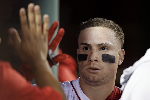 Boston Red Sox's Christian Vazquez is congratulated by teammates after his solo home run during the fifth inning of a baseball game against the Los Angeles Angels at Fenway Park in Boston, Tuesday, June 26, 2018. (AP Photo/Charles Krupa)