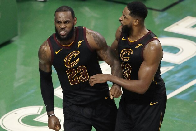 Cleveland Cavaliers forward LeBron James and center Tristan Thompson (13) celebrate near the end of the second half in Game 7 of the NBA basketball Eastern Conference finals, Sunday, May 27, 2018, in Boston. (AP Photo/Charles Krupa)