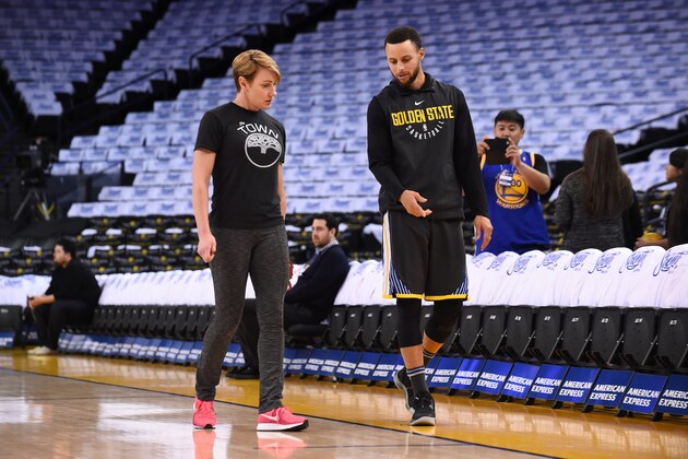 OAKLAND, CA - APRIL 7:  Stephen Curry #30 of the Golden State Warriors speaks with Head Performance Therapist Chelsea Lane before the game against the New Orleans Pelicans on April 7, 2018 at ORACLE Arena in Oakland, California. NOTE TO USER: User expressly acknowledges and agrees that, by downloading and or using this photograph, user is consenting to the terms and conditions of Getty Images License Agreement. Mandatory Copyright Notice: Copyright 2018 NBAE (Photo by Noah Graham/NBAE via Getty Images)