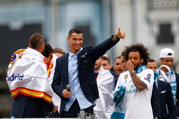 Real Madrid's Portuguese forward Cristiano Ronaldo celebrates with teammates on an open-air bus at Cibeles square in Madrid on May 27, 2018 after Real Madrid won their third Champions League title in a row in Kiev. (Photo by BENJAMIN CREMEL / AFP)        (Photo credit should read BENJAMIN CREMEL/AFP/Getty Images)