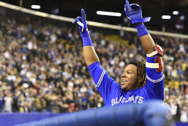 MONTREAL, QC - MARCH 27:  Vladimir Guerrero Jr. #27 of the Toronto Blue Jays acknowledges the fans after hitting a home run in the bottom of the ninth against the St. Louis Cardinals during the MLB preseason game at Olympic Stadium on March 27, 2018 in Montreal, Quebec, Canada.  The Toronto Blue Jays defeated the St. Louis Cardinals 1-0.  (Photo by Minas Panagiotakis/Getty Images)