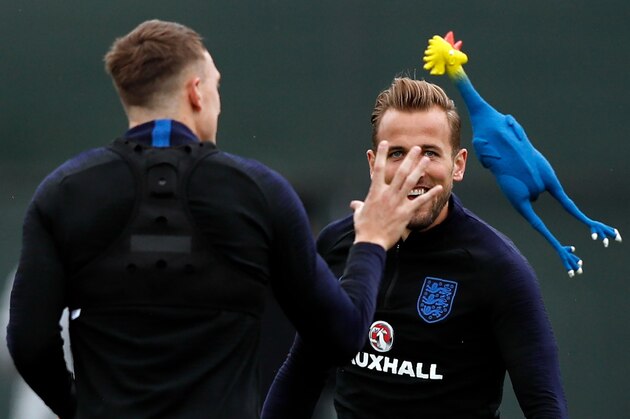 England's forward Harry Kane (R) looks on as defender Phil Jones (L) tries to catch a toy rooster  as they take part in a training session in Repino on July 10, 2018 ahead of their semi-final match against Croatia during the Russia 2018 World Cup football tournament. (Photo by ADRIAN DENNIS / AFP)        (Photo credit should read ADRIAN DENNIS/AFP/Getty Images)