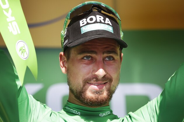 Slovakia's Peter Sagan, wearing the best sprinter's green jersey, celebrates on the podium after the third stage of the Tour de France cycling race, a team time trial over 35.5 kilometers (22 miles) with start and finish in Cholet, France, Monday, July 9, 2018. (AP Photo/Christophe Ena)