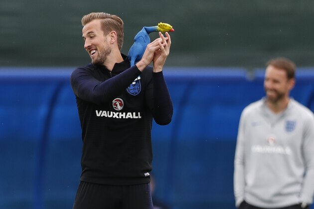 England's Harry Kane fails to catch a rubber chicken used in a game of tag as he takes part in a training session for the England team at the 2018 soccer World Cup, in the Spartak Zelenogorsk ground, Zelenogorsk near St. Petersburg, Russia, Tuesday, July 10, 2018. (AP Photo/Alastair Grant)