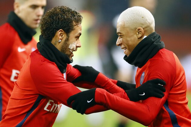 PSG's Neymar, left, and Kylian Mbappe warm up prior to their French League One soccer match between Paris Saint Germain and Caen, at the Parc des Princes stadium in Paris, France, Wednesday, Dec. 20, 2017. (AP Photo/Francois Mori)