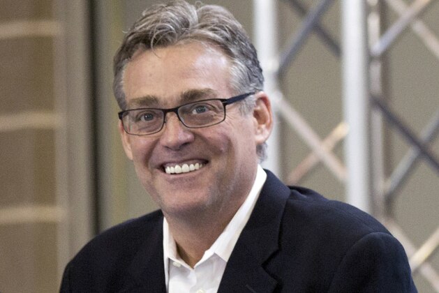 FILE - In this April 23, 2015, file photo, San Antonio Spurs general manager R.C. Buford smiles during an NBA basketball news conference in San Antonio. Buford has been named the NBA's executive of the year, the league announced Monday, May 9, 2016. It's the second time Buford has received the honor. He previously won it in the 2013-14 season. (AP Photo/Eric Gay, File)