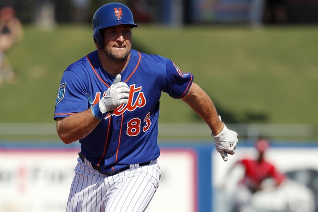 New York Mets' Tim Tebow runs toward third during the fourth inning of an exhibition spring training baseball game against the Washington Nationals Friday, March 2, 2018, in Port St. Lucie, Fla. (AP Photo/Jeff Roberson)