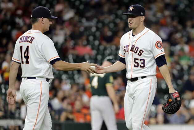 Houston Astros manager AJ Hinch (14) pulls relief pitcher Ken Giles (53) from the baseball game during the ninth inning against the Oakland Athletics on Tuesday, July 10, 2018, in Houston. (AP Photo/David J. Phillip)
