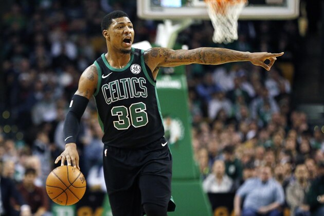 Boston Celtics' Marcus Smart signals during the first quarter of an NBA basketball game against the Indiana Pacers in Boston, Sunday, March 11, 2018. (AP Photo/Michael Dwyer)