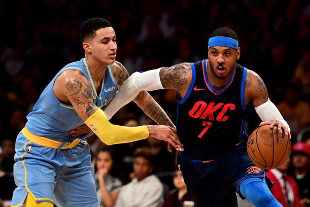 LOS ANGELES, CA - JANUARY 03:  Carmelo Anthony #7 of the Oklahoma City Thunder drives on Kyle Kuzma #0 of the Los Angeles Lakers during the first half at Staples Center on January 3, 2018 in Los Angeles, California.  (Photo by Harry How/Getty Images)