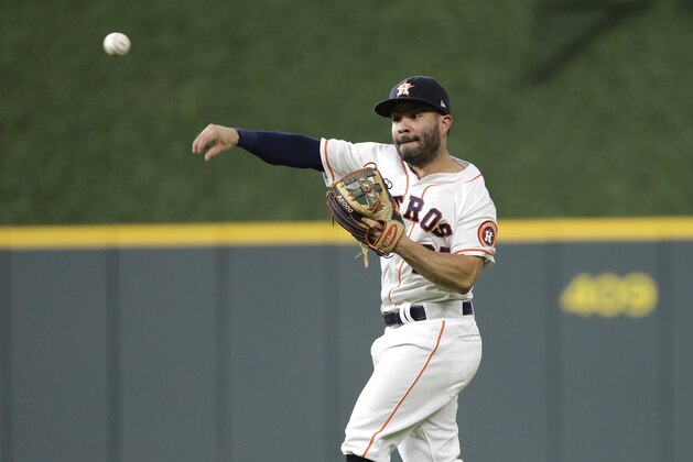 Houston Astros second baseman Jose Altuve throws to first after fielding a hit by Oakland Athletics' Jonathan Lucroy during the third inning of a baseball game Monday, July 9, 2018, in Houston. (AP Photo/David J. Phillip)