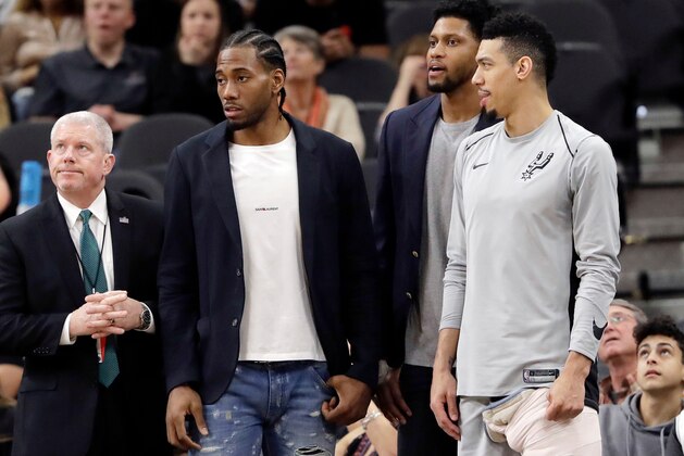 FILE - In this Jan. 21, 2018, file photo, San Antonio Spurs guard Danny Green, right, stands at the bench with injured teammates Kawhi Leonard, second from left, and Rudy Gay, center, during the second half of an NBA basketball game against the Indiana Pacers in San Antonio. General manager R.C. Buford acknowledges star forward Kawhi Leonard is unhappy with the Spurs. He remains optimistic the relationship can be salvaged. (AP Photo/Eric Gay, File)