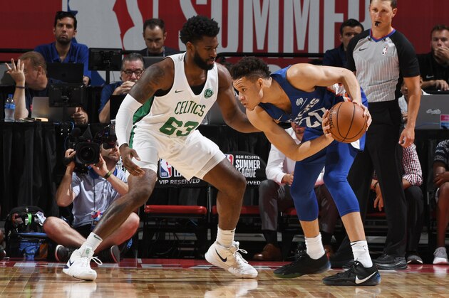 LAS VEGAS, NV - JULY 12:  Kevin Knox #20 of the New York Knicks handles the ball against Hassan Martin #63 of the Boston Celtics during the 2018 Las Vegas Summer League on July 12, 2018 at the Thomas & Mack Center in Las Vegas, Nevada. NOTE TO USER: User expressly acknowledges and agrees that, by downloading and/or using this Photograph, user is consenting to the terms and conditions of the Getty Images License Agreement. Mandatory Copyright Notice: Copyright 2018 NBAE (Photo by Garrett Ellwood/NBAE via Getty Images)