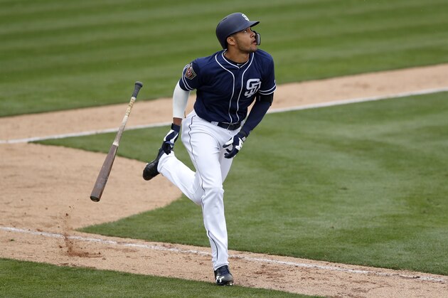 San Diego Padres shortstop Fernando Tatis hits a home run during the eighth inning of a spring training baseball game against the Seattle Mariners, Friday, Feb. 23, 2018, in Peoria, Ariz. (AP Photo/Charlie Neibergall)