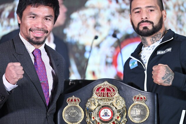 Philippine's Manny Pacquiao (L) and Argentina's Lucas Matthysse (R) pose for pictures with the welterweight championship belt after the press conference on July 12, 2018, ahead their fight on July 15. (Photo by Mohd RASFAN / AFP)        (Photo credit should read MOHD RASFAN/AFP/Getty Images)