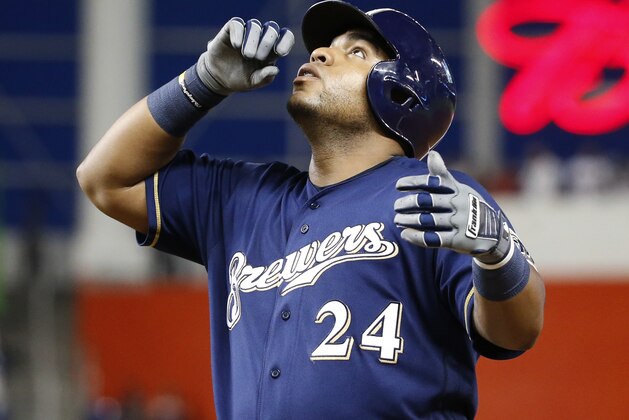 Milwaukee Brewers' Jesus Aguilar celebrates after getting a base hit during the fourth inning of the team's baseball game against the Miami Marlins, Wednesday, July 11, 2018, in Miami. (AP Photo/Wilfredo Lee)