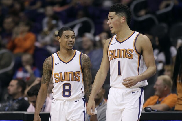 Phoenix Suns' Tyler Ulis (8) and Devin Booker talk as they walk back on to the court following a timeout during an NBA basketball exhibition game against Australia's Brisbane Bullets Friday, Oct. 13, 2017, in Phoenix. The Suns defeated the Bullets 114-93. (AP Photo/Ralph Freso)