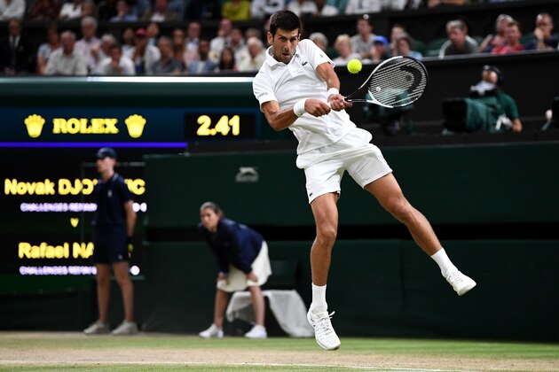 LONDON, ENGLAND - JULY 13:  Novak Djokovic of Serbia returns against Rafael Nadal of Spain during their Men's Singles semi-final match on day eleven of the Wimbledon Lawn Tennis Championships at All England Lawn Tennis and Croquet Club on July 13, 2018 in London, England.  (Photo by Clive Mason/Getty Images)