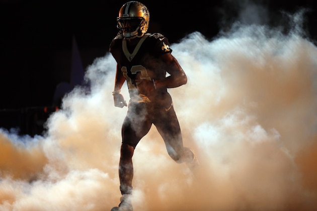 New Orleans Saints wide receiver Michael Thomas (13) runs on the field for player introductions during pre-game ceremonies before an NFL football game against the Carolina Panthers in New Orleans, Sunday, Dec. 3, 2017. (AP Photo/Gerald Herbert)