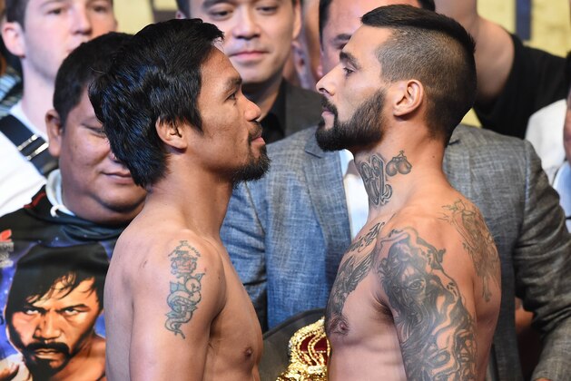 Philippines' Manny Pacquiao (L) and Argentina's Lucas Matthysse pose for pictures after the weigh-in event in Kuala Lumpur on July 14, 2018, ahead of their world welterweight boxing championship bout on July 15. (Photo by Mohd RASFAN / AFP)        (Photo credit should read MOHD RASFAN/AFP/Getty Images)