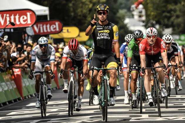 Netherlands' Dylan Groenewegen (C) celebrates as he crosses the finish line ahead of Germany's Andre Greipel (R) to win the eighth stage of the 105th edition of the Tour de France cycling race between Dreux and Amiens, northern France, on July 14, 2018. (Photo by Marco BERTORELLO / AFP)        (Photo credit should read MARCO BERTORELLO/AFP/Getty Images)