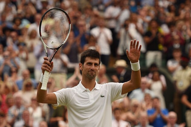 Serbia's Novak Djokovic celebrates after winning against Spain's Rafael Nadal during the continuation of their men's singles semi-final match on the twelfth day of the 2018 Wimbledon Championships at The All England Lawn Tennis Club in Wimbledon, southwest London, on July 14, 2018. - Djokovic won the match 6-4, 3-6, 7-6, 3-6, 10-8. (Photo by Oli SCARFF / AFP) / RESTRICTED TO EDITORIAL USE        (Photo credit should read OLI SCARFF/AFP/Getty Images)