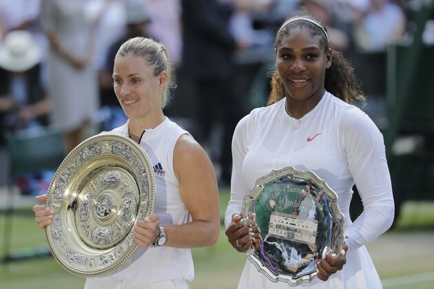 Angelique Kerber of Germany holds the winner's trophy after defeating Serena Williams of the United States, right, in the women's singles final match at the Wimbledon Tennis Championships, in London, Saturday July 14, 2018. (AP Photo/Ben Curtis)