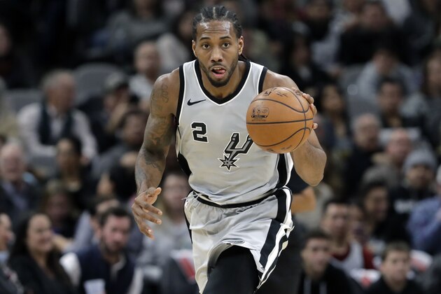 San Antonio Spurs forward Kawhi Leonard (2) moves the ball up court during the second half of an NBA basketball game against the Denver Nuggets, Saturday, Jan. 13, 2018, in San Antonio. San Antonio won 112-80. (AP Photo/Eric Gay)