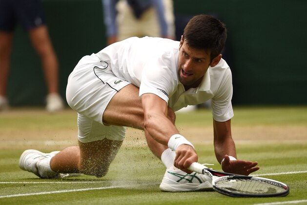 TOPSHOT - Serbia's Novak Djokovic fails to return to Spain's Rafael Nadal during the continuation of their men's singles semi-final match on the twelfth day of the 2018 Wimbledon Championships at The All England Lawn Tennis Club in Wimbledon, southwest London, on July 14, 2018. (Photo by Oli SCARFF / AFP) / RESTRICTED TO EDITORIAL USE        (Photo credit should read OLI SCARFF/AFP/Getty Images)