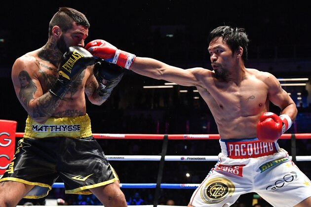 Philippines' Manny Pacquiao (R) fights Argentina's Lucas Matthysse during their world welterweight boxing championship bout at Axiata Arena in Kuala Lumpur on July 15, 2018. (Photo by Mohd RASFAN / AFP)        (Photo credit should read MOHD RASFAN/AFP/Getty Images)