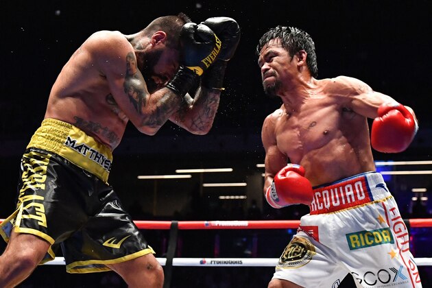 Philippines' Manny Pacquiao (R) fights Argentina's Lucas Matthysse during their world welterweight boxing championship bout at Axiata Arena in Kuala Lumpur on July 15, 2018. (Photo by Mohd RASFAN / AFP)        (Photo credit should read MOHD RASFAN/AFP/Getty Images)