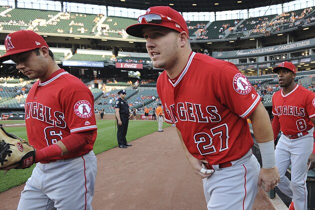 Los Angeles Angels' Mike Trout, center walks onto the field before playing the Baltimore Orioles in a baseball game, Friday, June 29, 2018, in Baltimore. (AP Photo/Gail Burton)